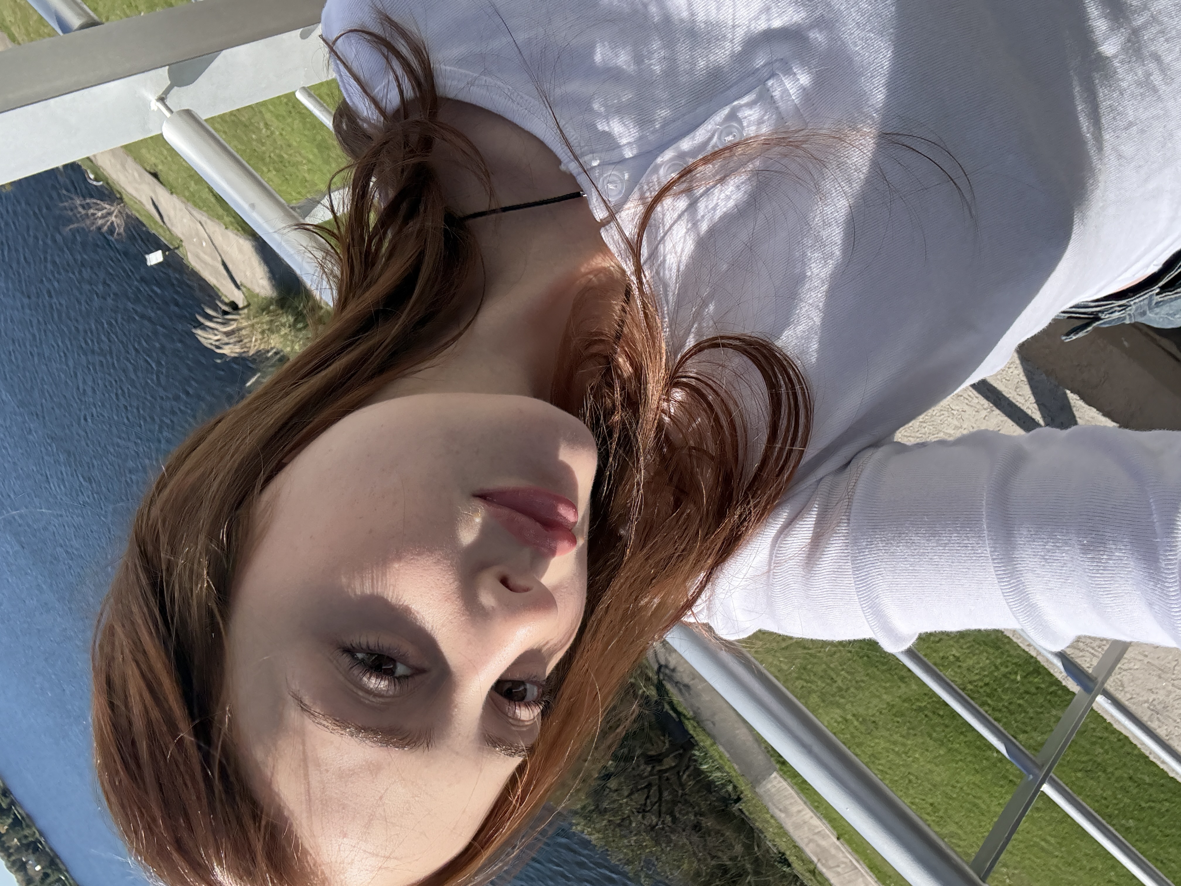 Maria taking a sunny close-up selfie by the water
